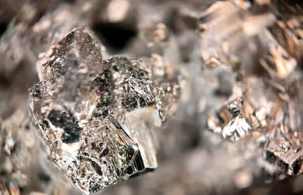 Macro photograph of bright, faceted metallic crystals